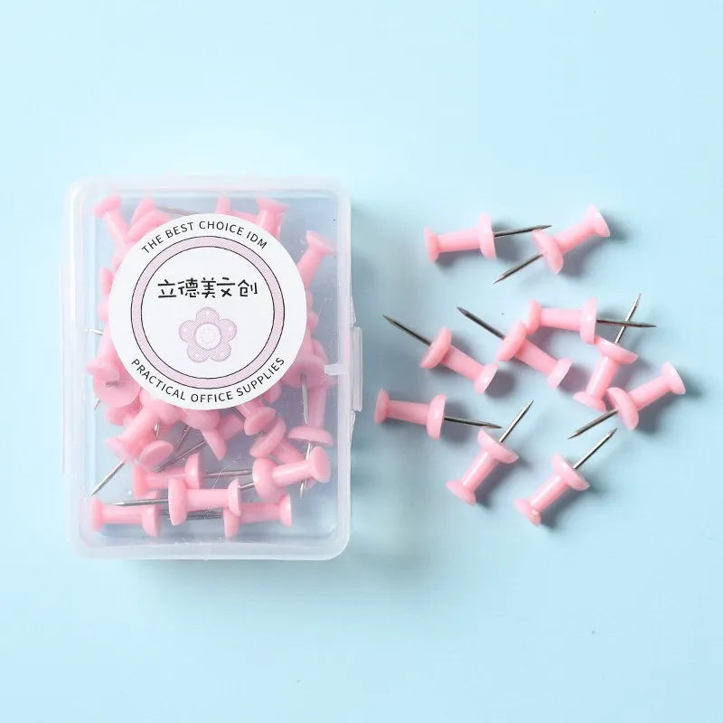 Plastic push pins in cherry blossom pink, mint green, and lavender, showing large and small sizes in a box.