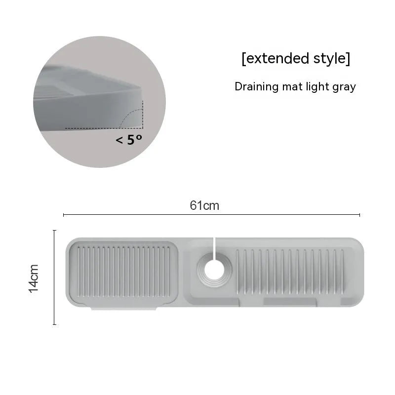 Silicone faucet splash guard pad in sloped design with drain channels on kitchen sink