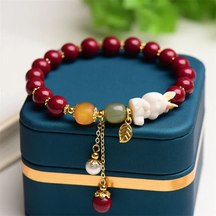 Natural cinnabar bracelet with rabbit motif in traditional Chinese design