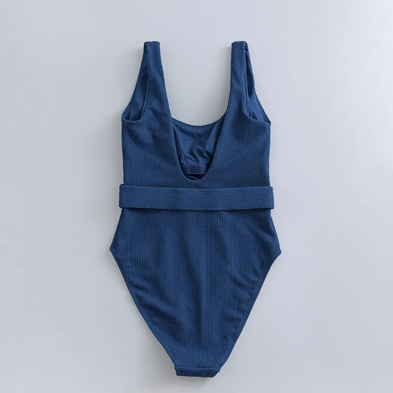 Navy blue women's one-piece swimsuit with triangle neckline and built-in chest pads