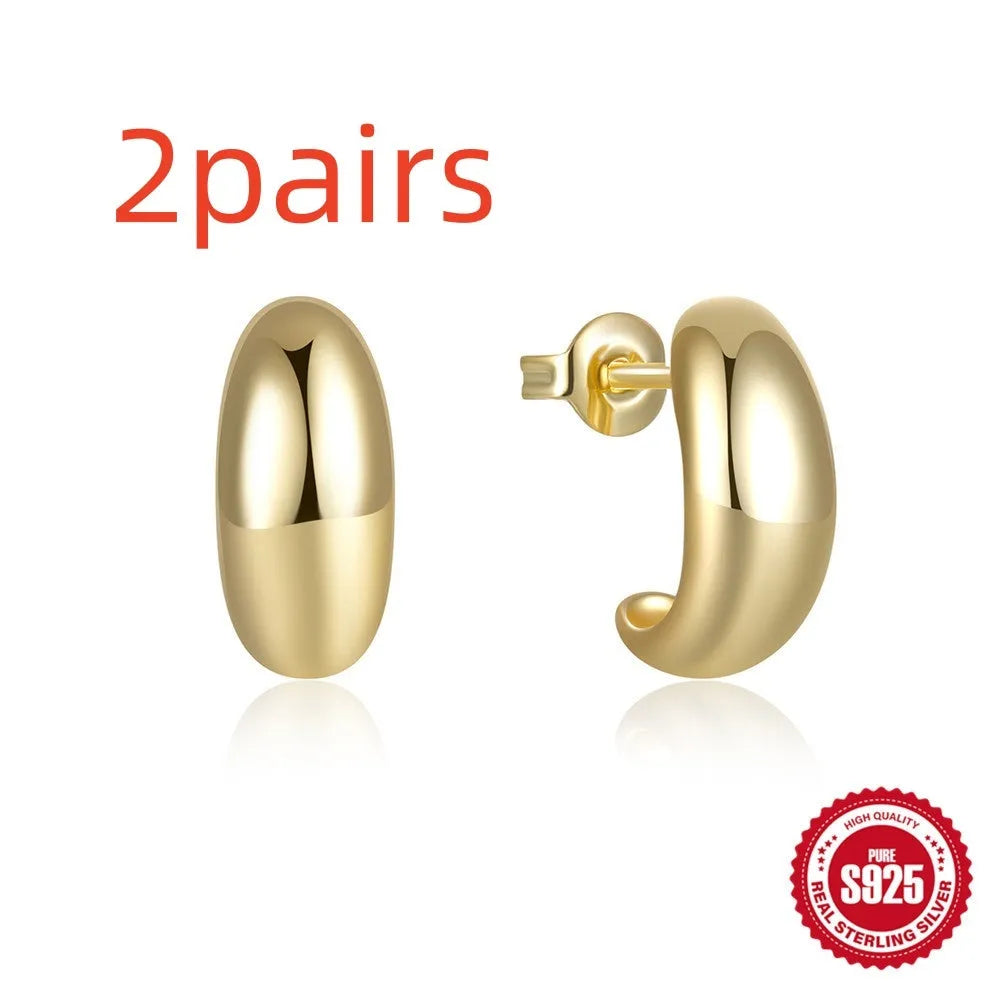 C-shaped sterling silver stud earrings with high polish gloss finish in gold colour