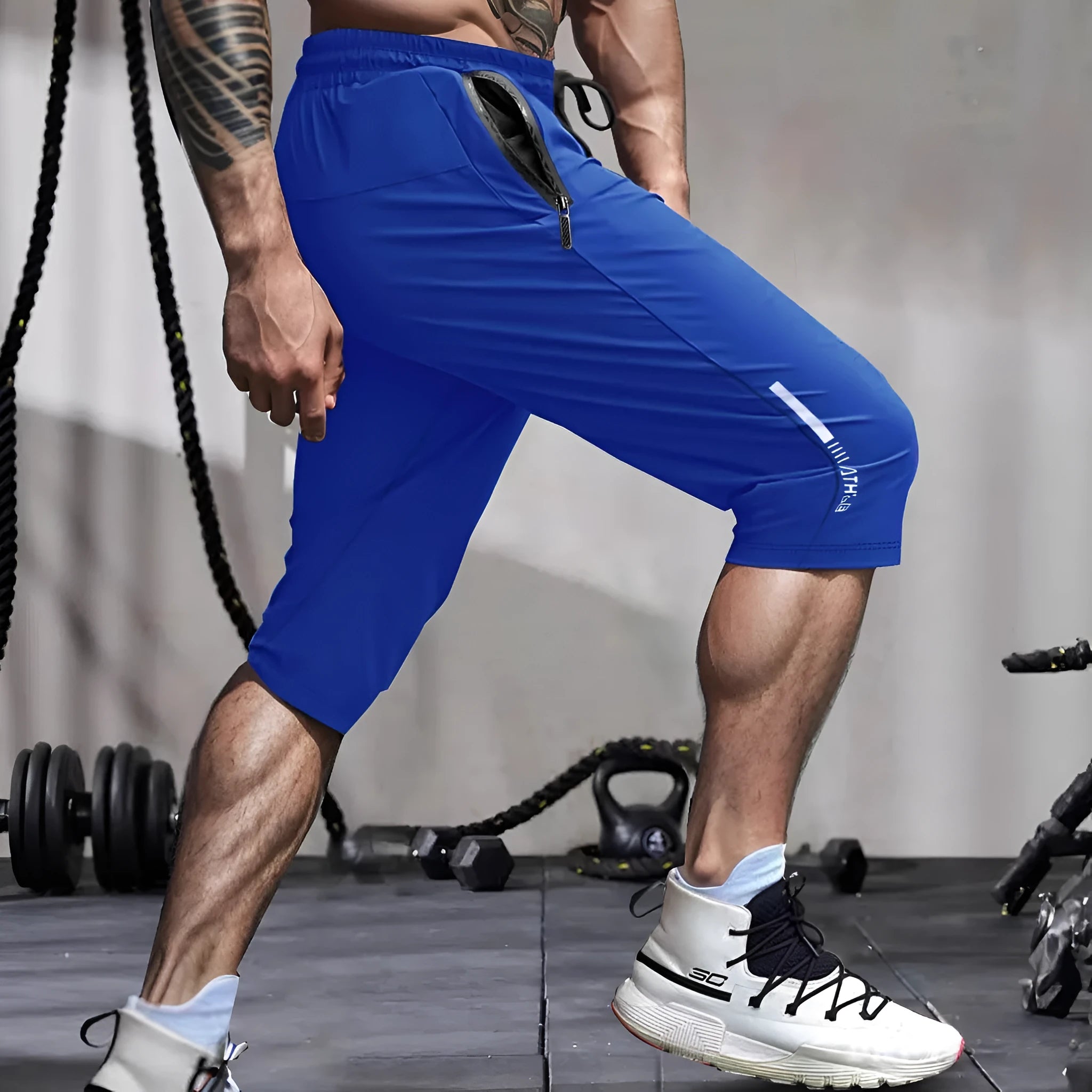 Men's grey ice silk cropped sports trousers with straight leg on a neutral background.
