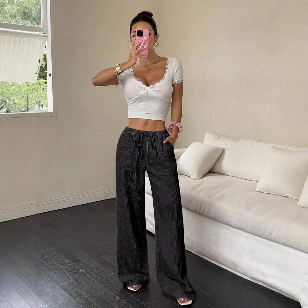 Women's black wide-leg trousers with lace-up waist detailing and adjustable ties