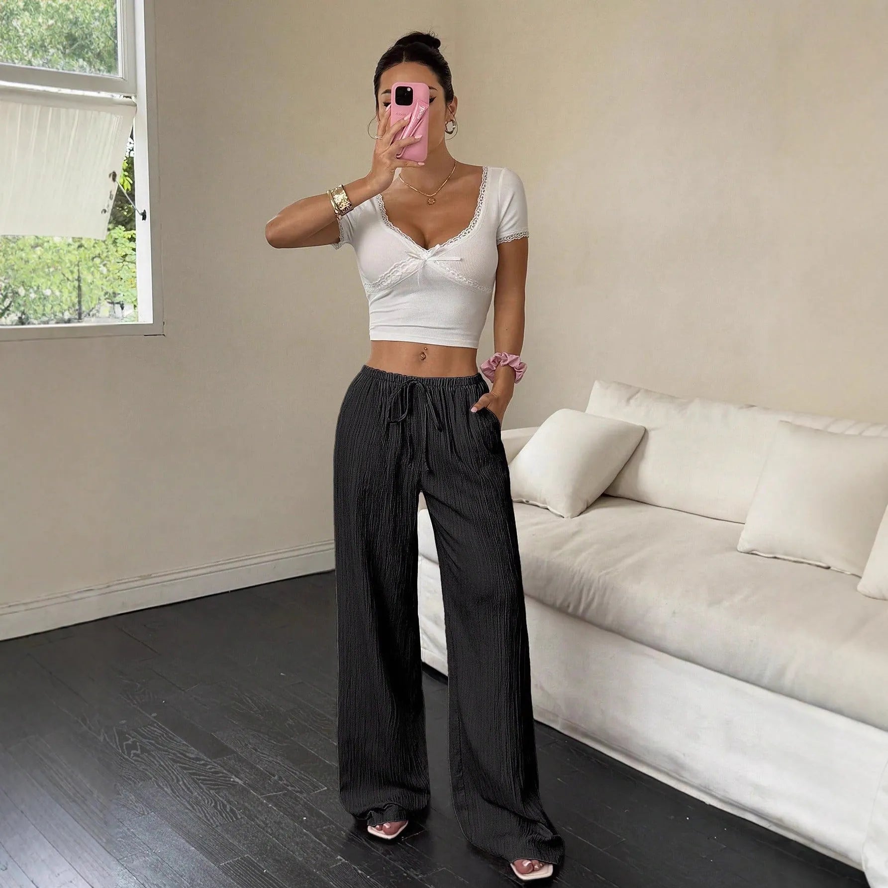 Women's black wide-leg trousers with lace-up waist detailing and adjustable ties