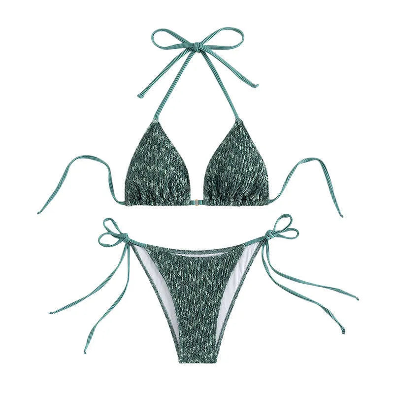 Women's green halter strap backless swimsuit top with matching shorts on hanger
