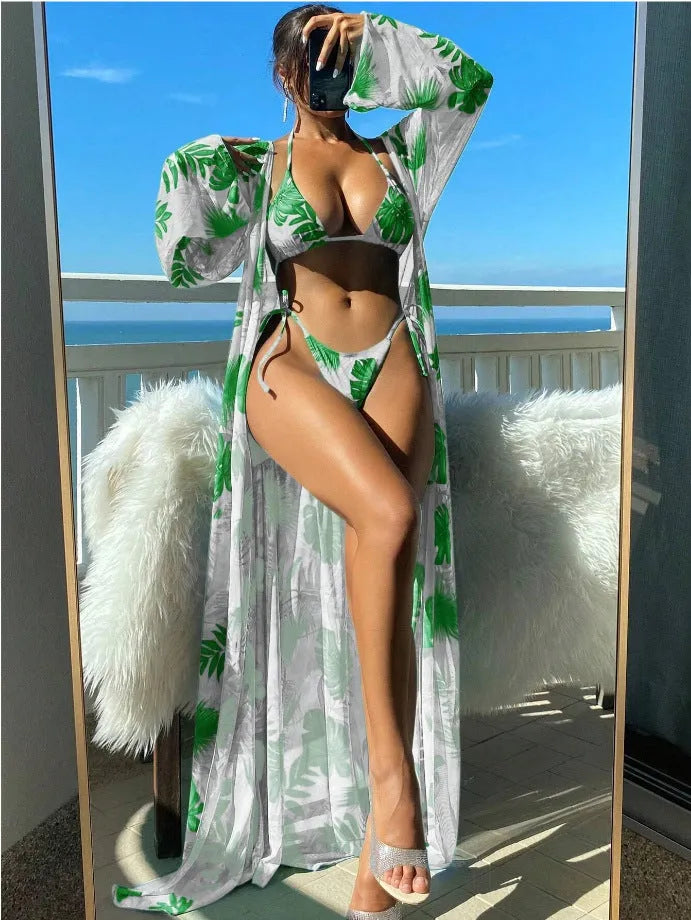 Women's long sleeve bikini set with floral pattern and matching robe on a hanger.