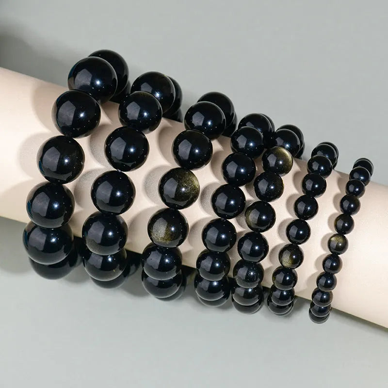 Hand-woven ethnic style unisex obsidian bracelet with round crystal beads.