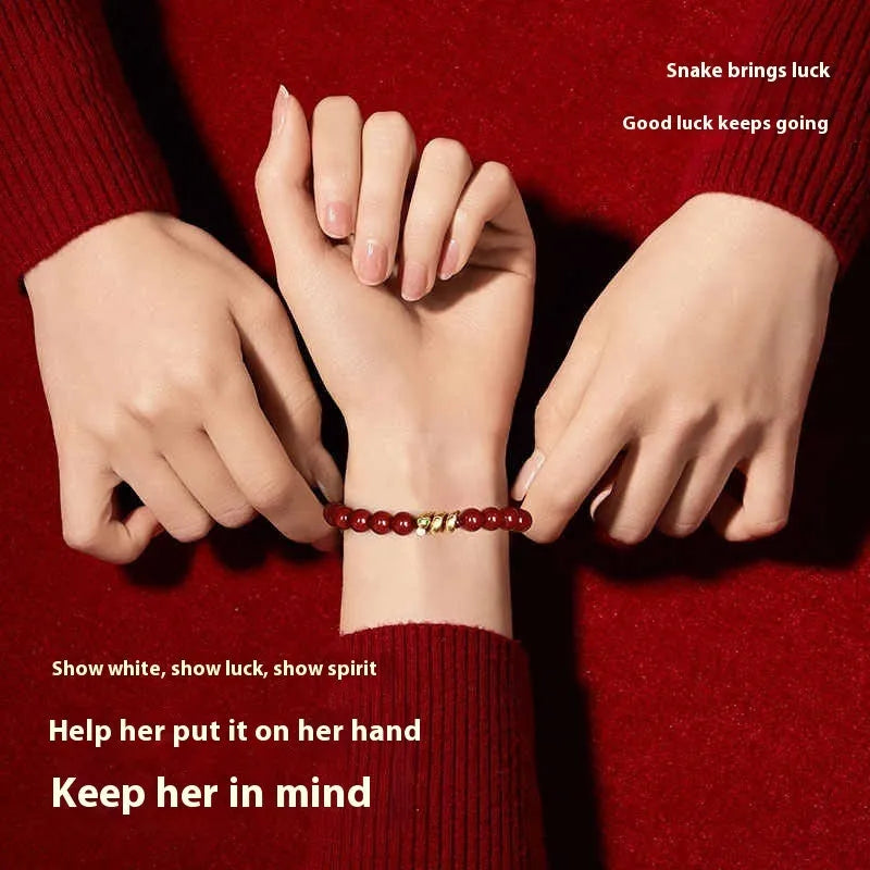 Handmade cinnabar snake year bracelet with Zodiac animal design, showing snake beads in traditional Chinese style.