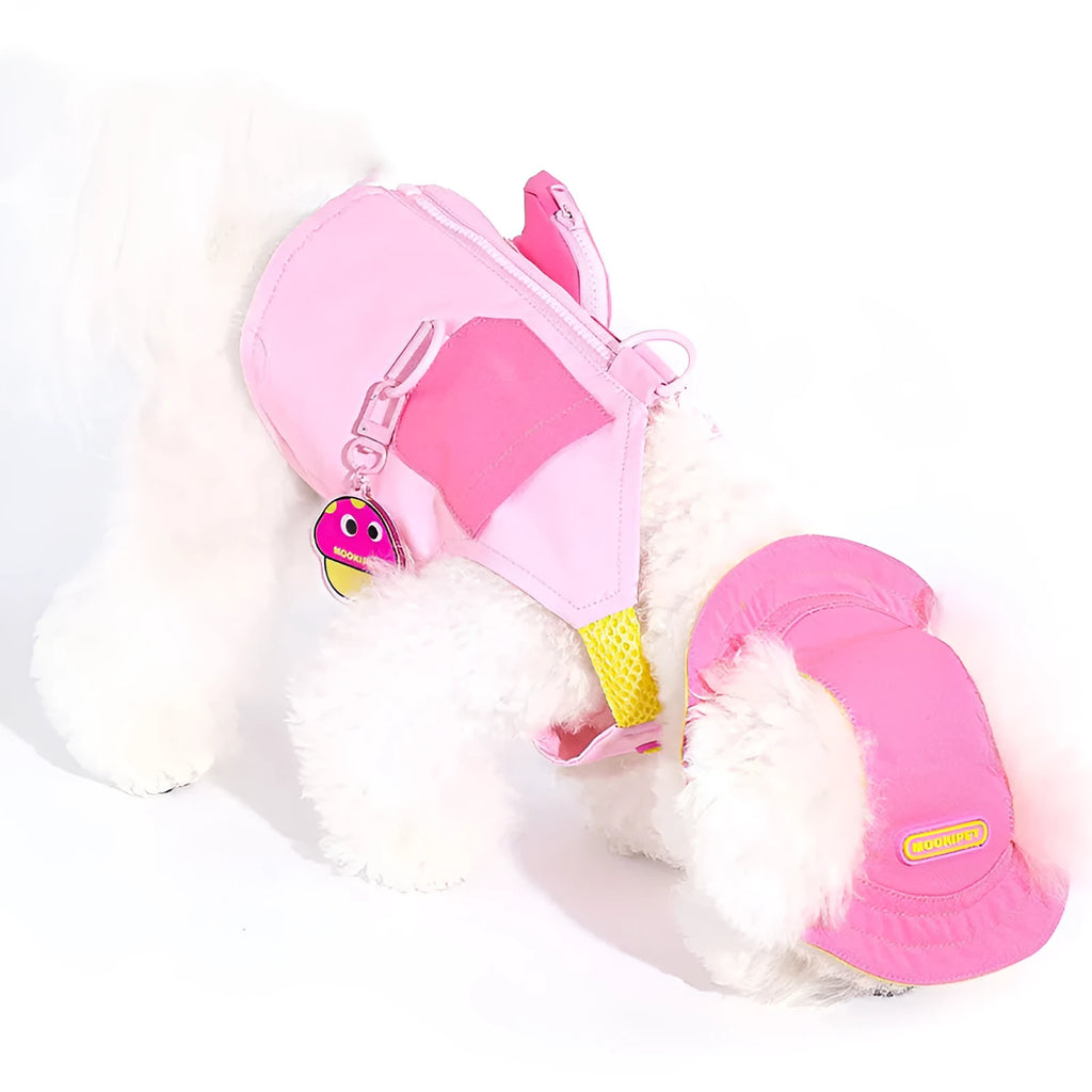 Pink adjustable traction vest on a small dog, showing the fit and fastening.