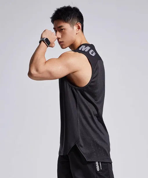 Man wearing a lightweight grey mesh sports vest, showing loose fit and breathable fabric for exercise.