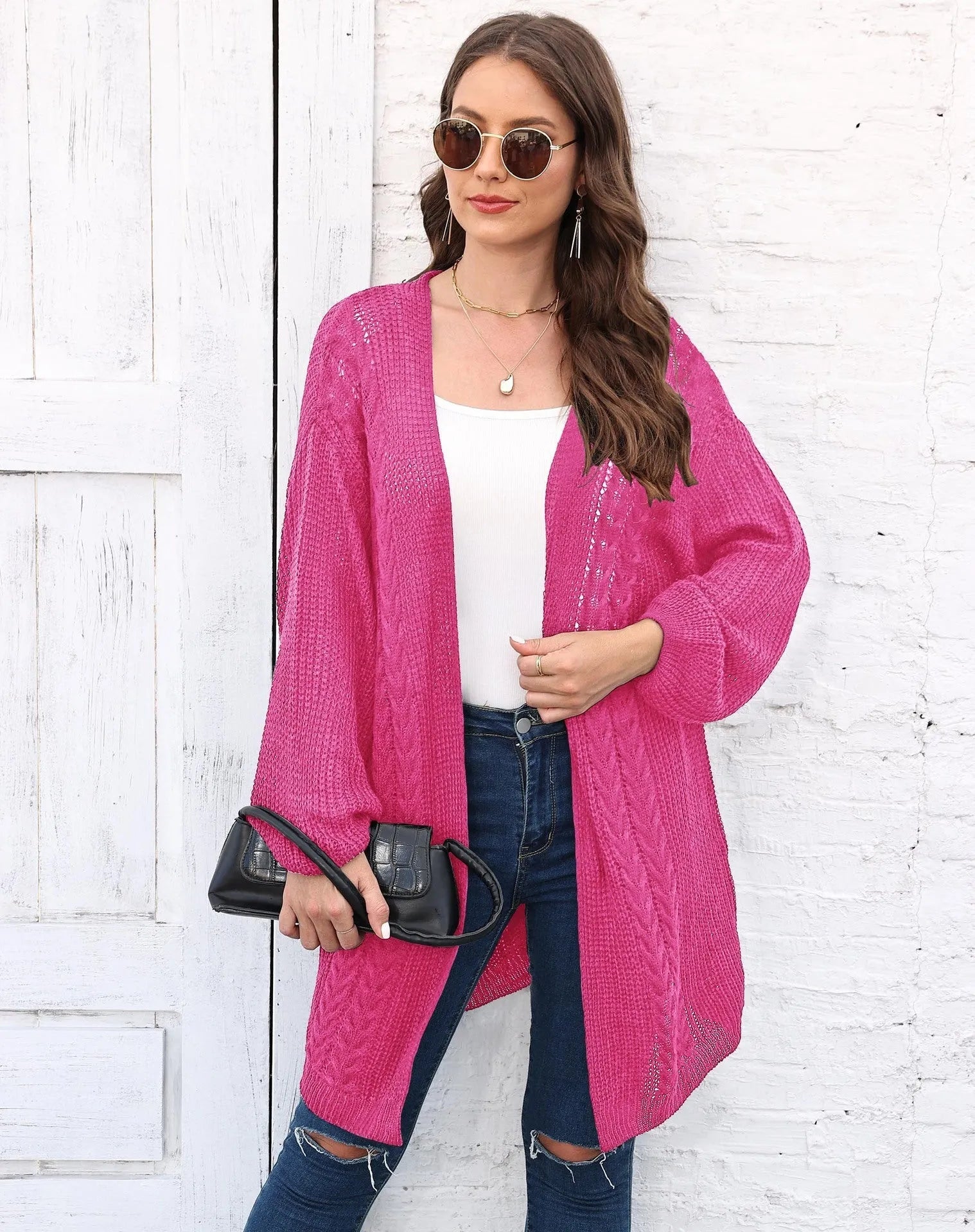 Women's loose acrylic sweater coat in solid colour on hanger