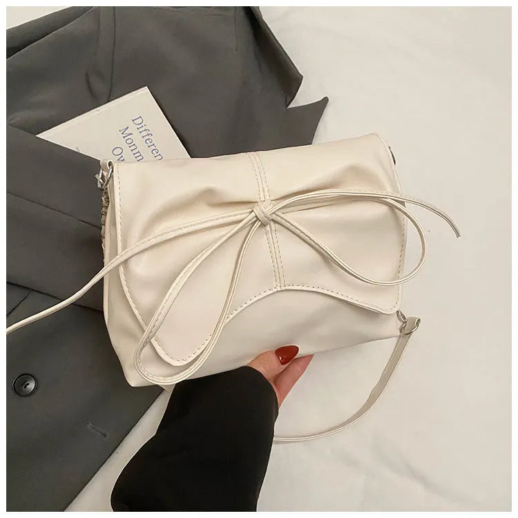 Women's black PU leather crossbody bag with horizontal square shape and visible sewing details