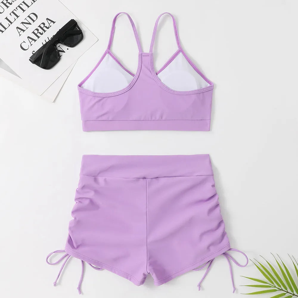 Women's violet high-waist split bikini swimsuit on a mannequin, showing top and shorts.