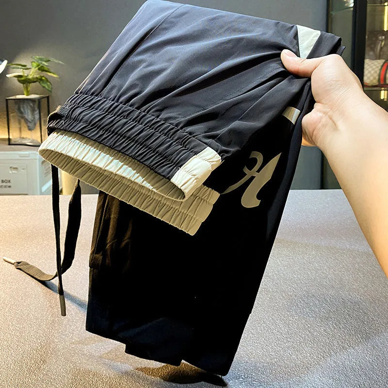 Black men's cropped casual trousers with ankle band made from ultra-thin ice silk cotton fabric.