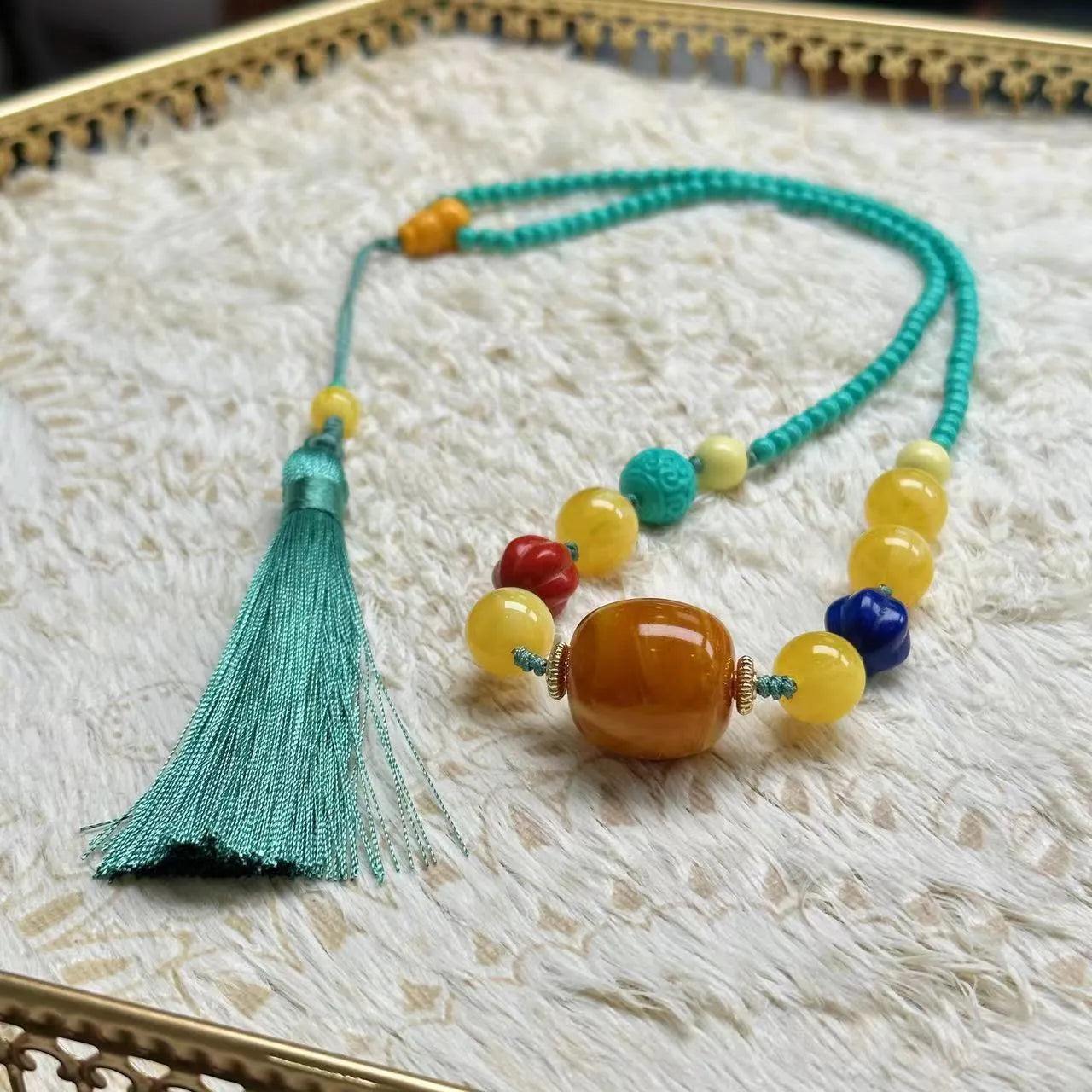 Hand-woven turquoise mesh flower lucky pendant on an adjustable ball bead necklace chain.