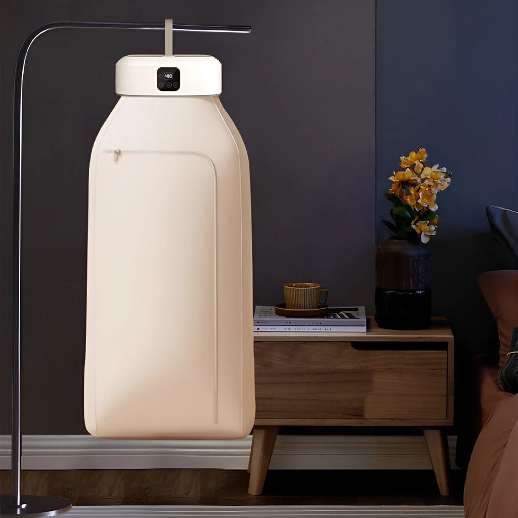 White cylindrical compact clothes dryer with remote control folded for storage