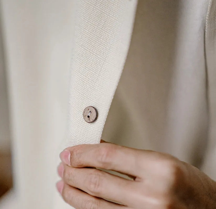 Light apricot men's shirt with bamboo plant print and a Cuban collar on a hanger