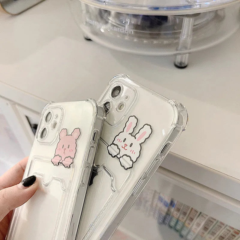 Transparent cartoon-design phone case with a card slot on the back, fitted on an iPhone.