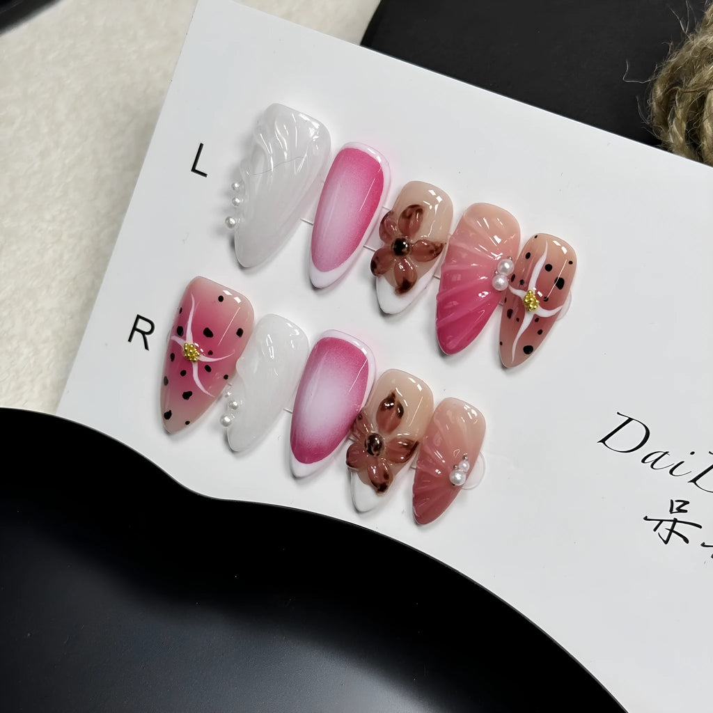 Hand-painted 3D candy pattern false nail art patches in almond shape on a plastic set.