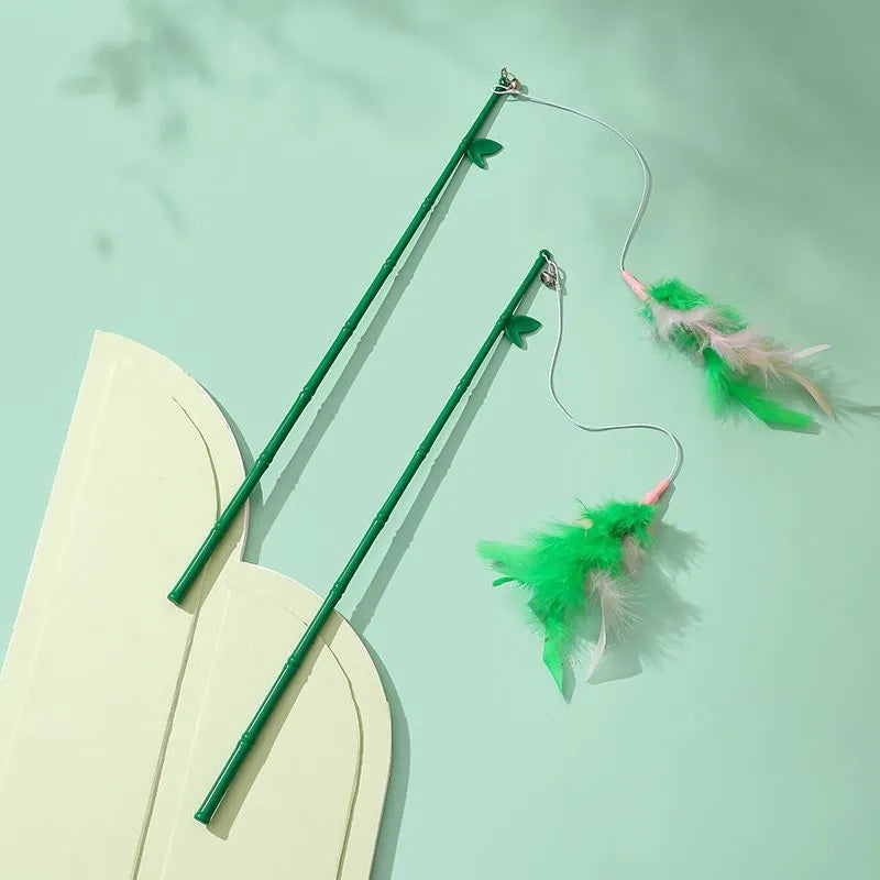 Green interactive cat feather wand toy with bell attachments for feline exercise and training