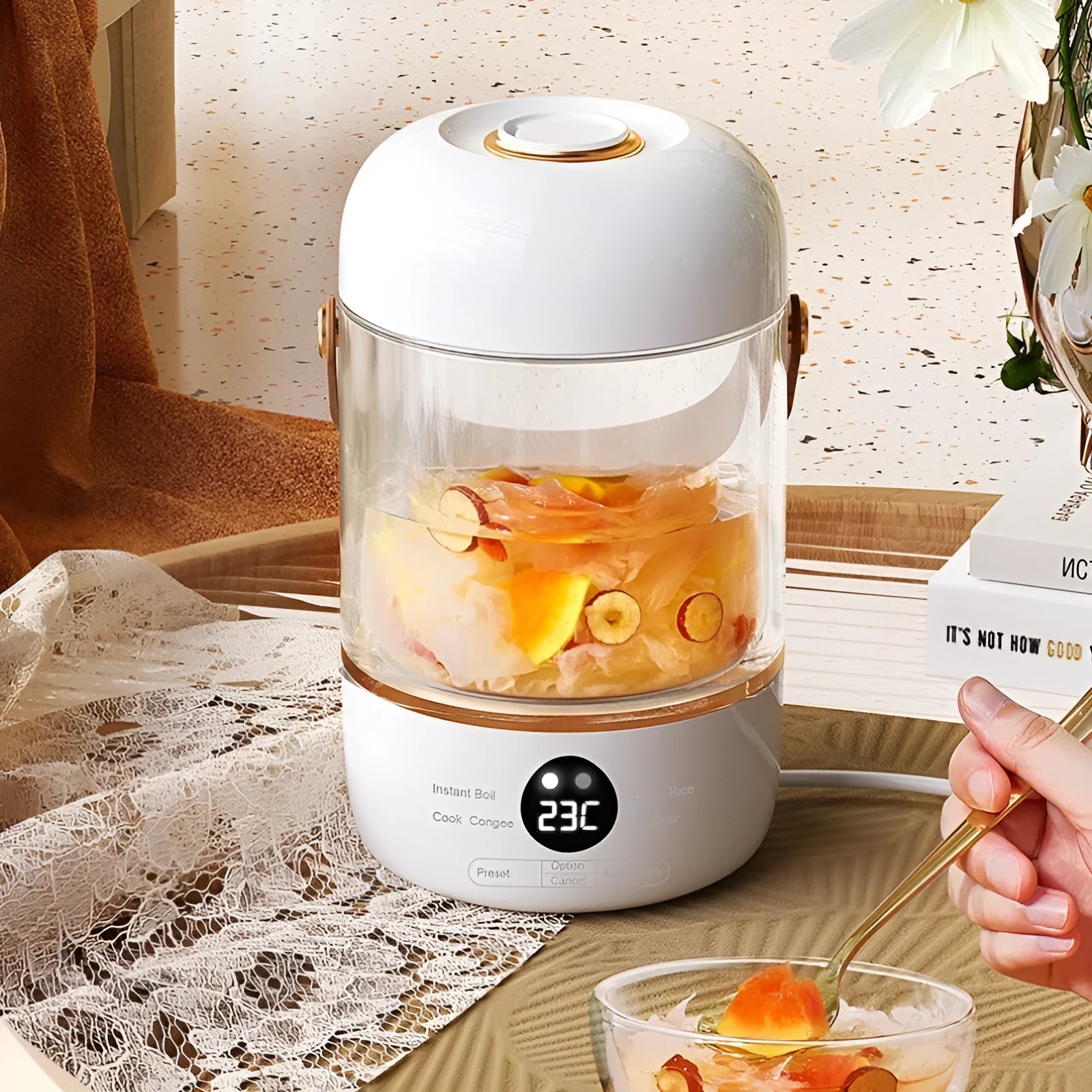 Smart electric stew cooker with transparent glass inner pot and fibre glass body, showing power cord and compact size