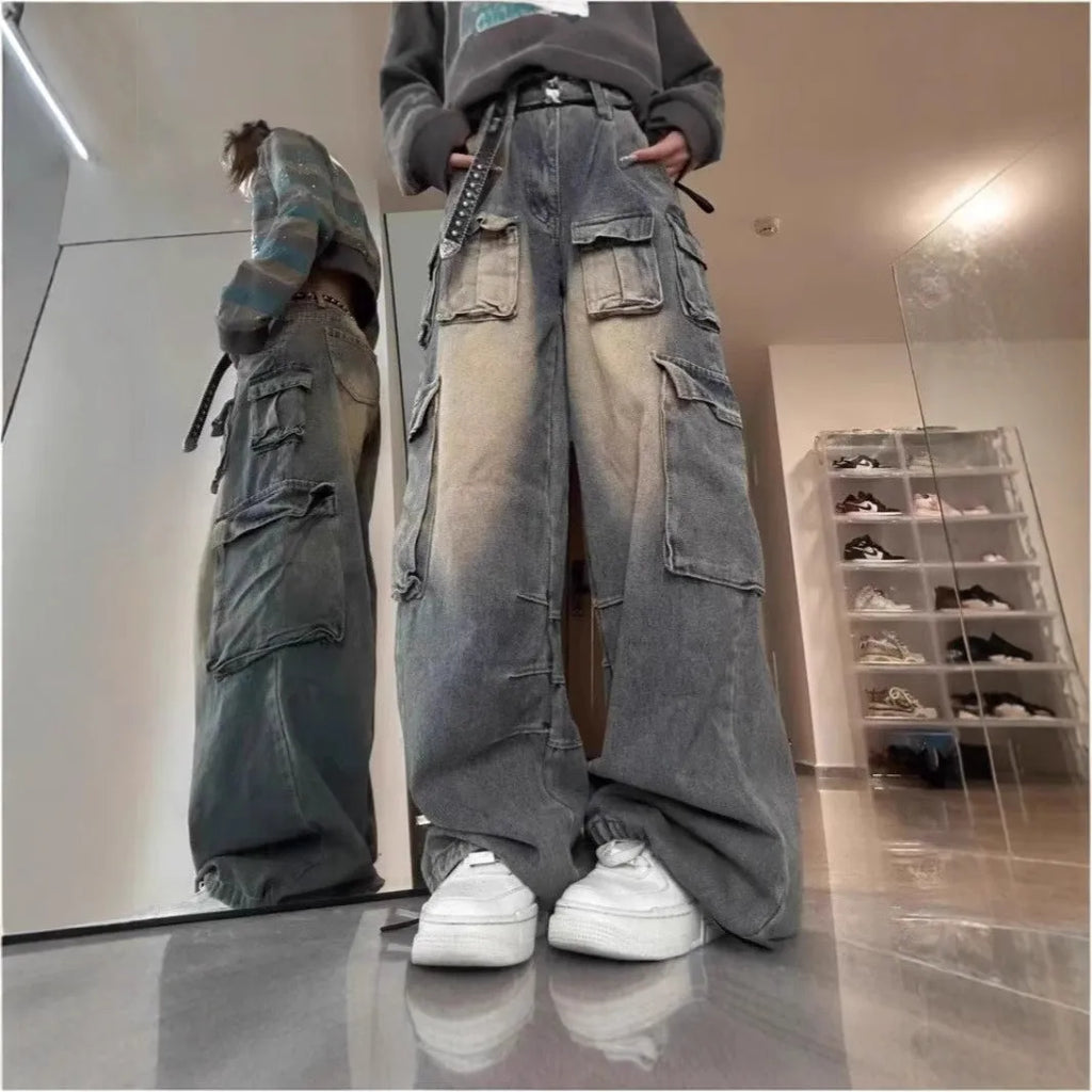 Loose fit distressed denim trousers with multiple pockets in light blue colour