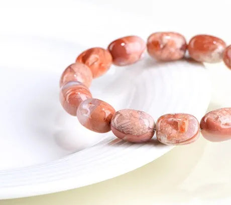 Natural cherry agate barrel bead bracelet with 10x14mm geometry and Ruyi design elements