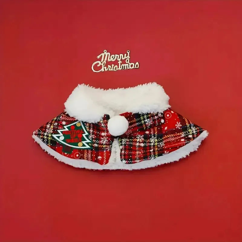 Pet wearing red Christmas cloak with bell design, draped over back with festive snowflake pattern