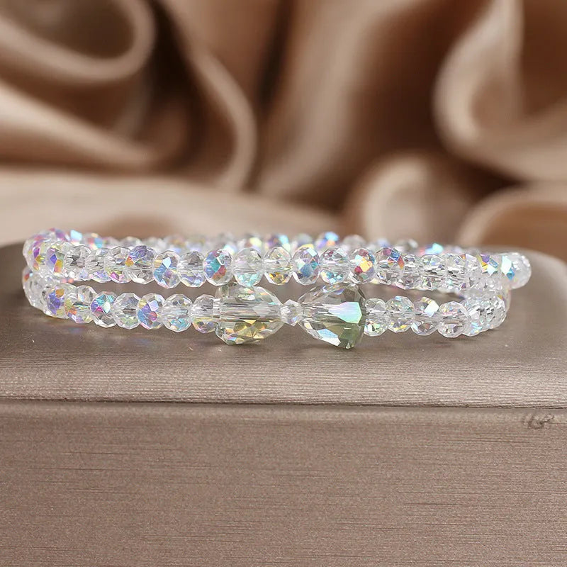 Women's double-circle crystal bow bracelet in white, green, and pink colour options on display