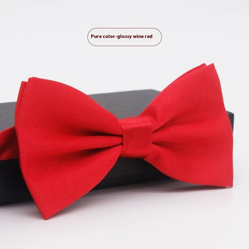 Men's flat head style polyester bow tie in a solid colour, shown with adjustable neck strap.