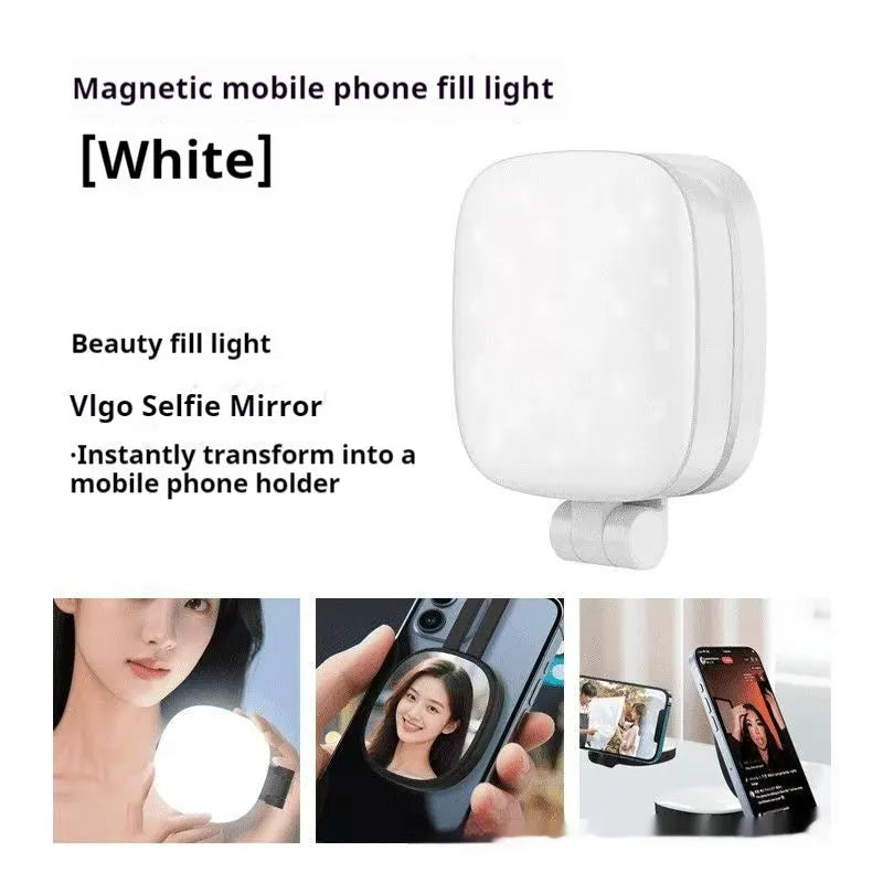 Black mini portable fill light with dial control magnetically attached to a mobile phone.