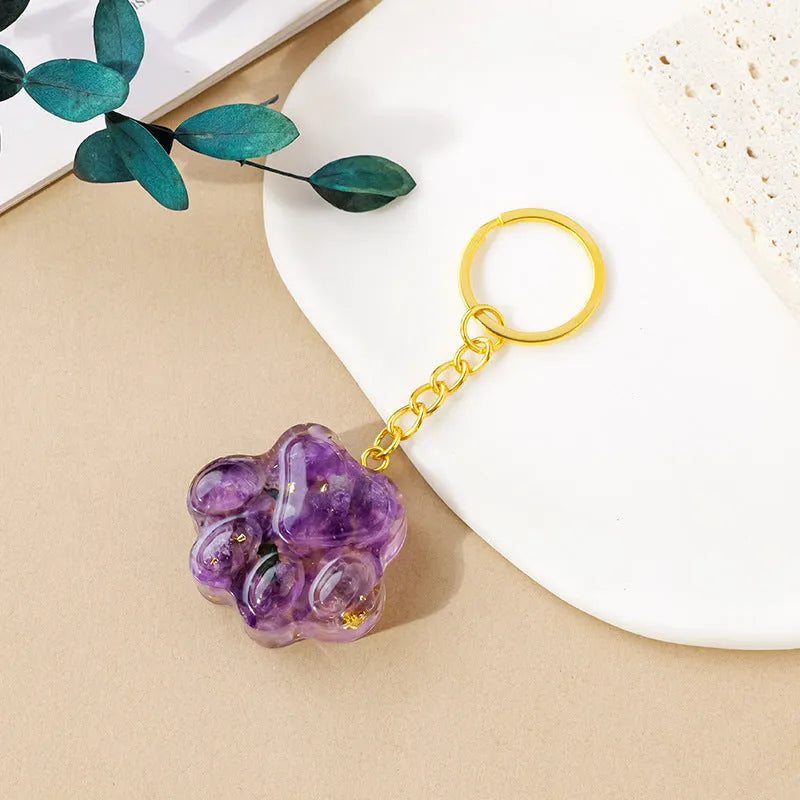 Natural crystal cat's paw keychain pendant in assorted gemstone colours on a keyring.