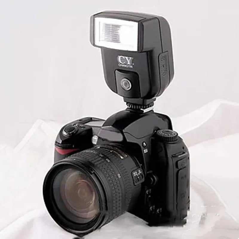 Silver hot shoe camera flash unit with head tilted upwards, shown mounted on an SLR camera