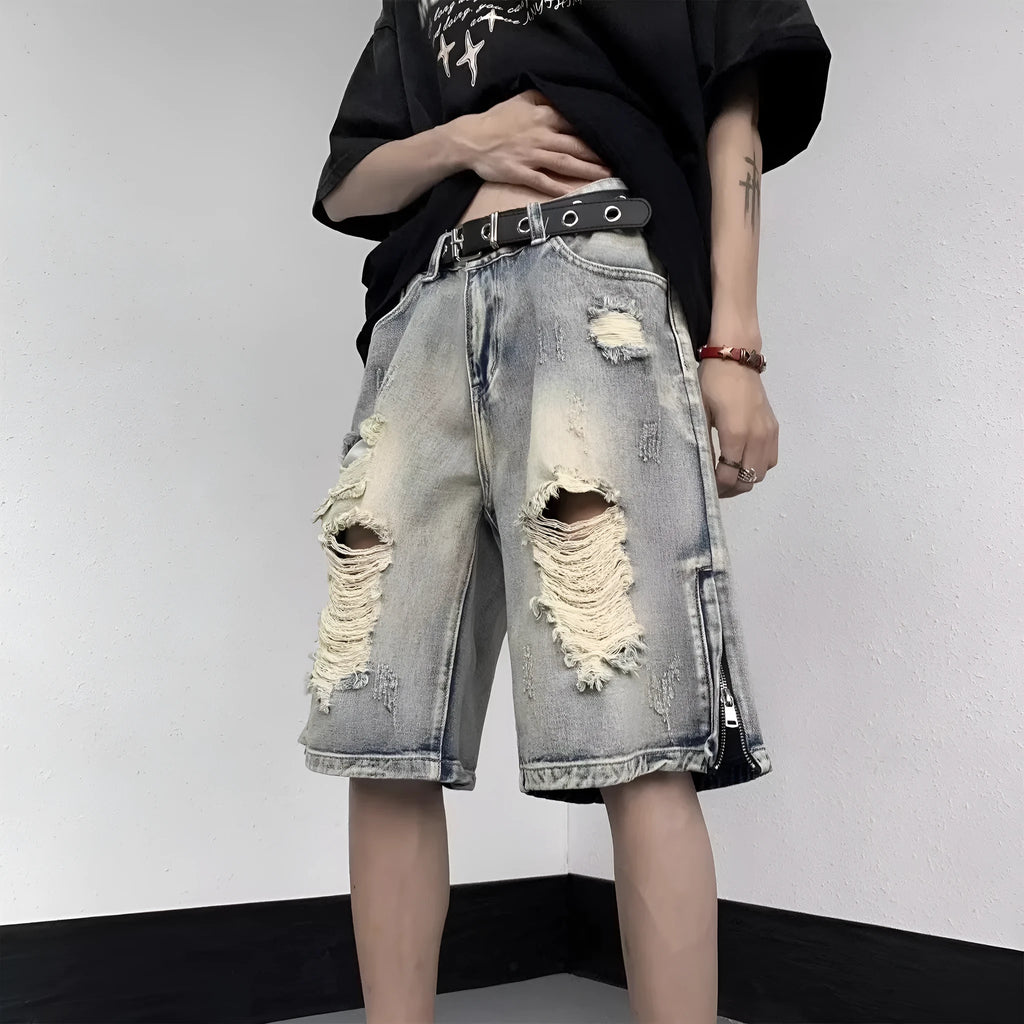 Blue retro tattered denim shorts with a wide leg and loose fit on a hanger.