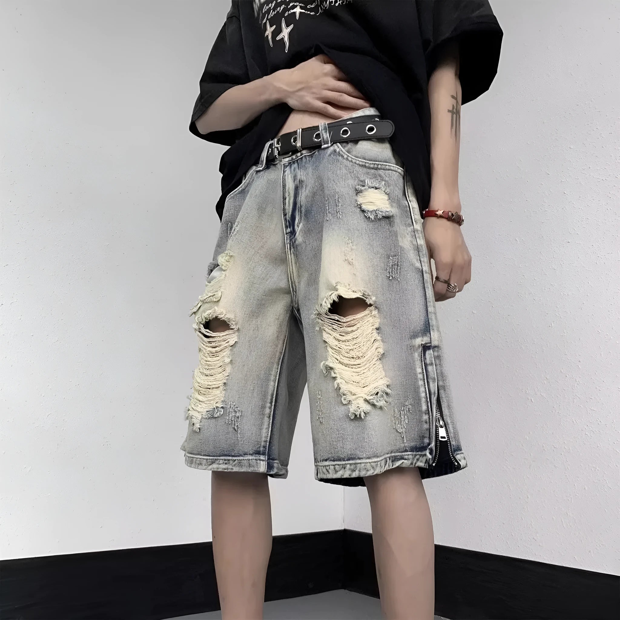 Blue retro tattered denim shorts with a wide leg and loose fit on a hanger.