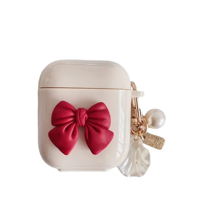 Beige AirPods case with red bow shell design, clamshell TPU earphone cover