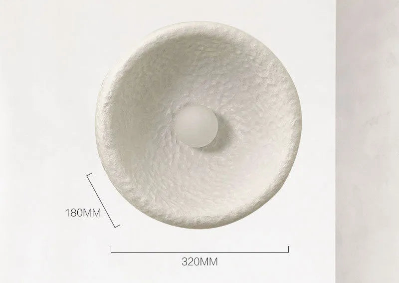 Japanese-style simple modern wall lamp with round resin shade in warm light