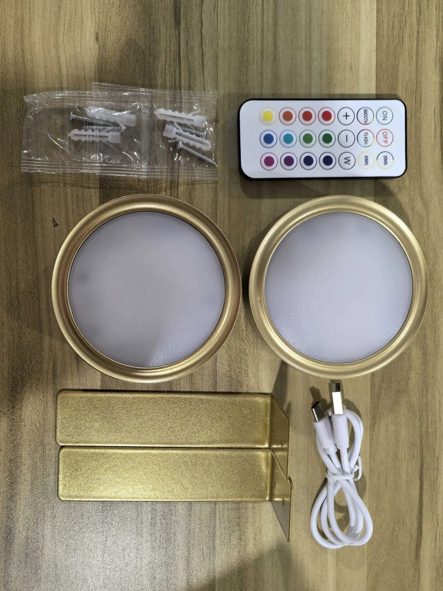 Wireless rechargeable LED painting lamp with magnetic belt attached to a metal frame, remote control nearby.
