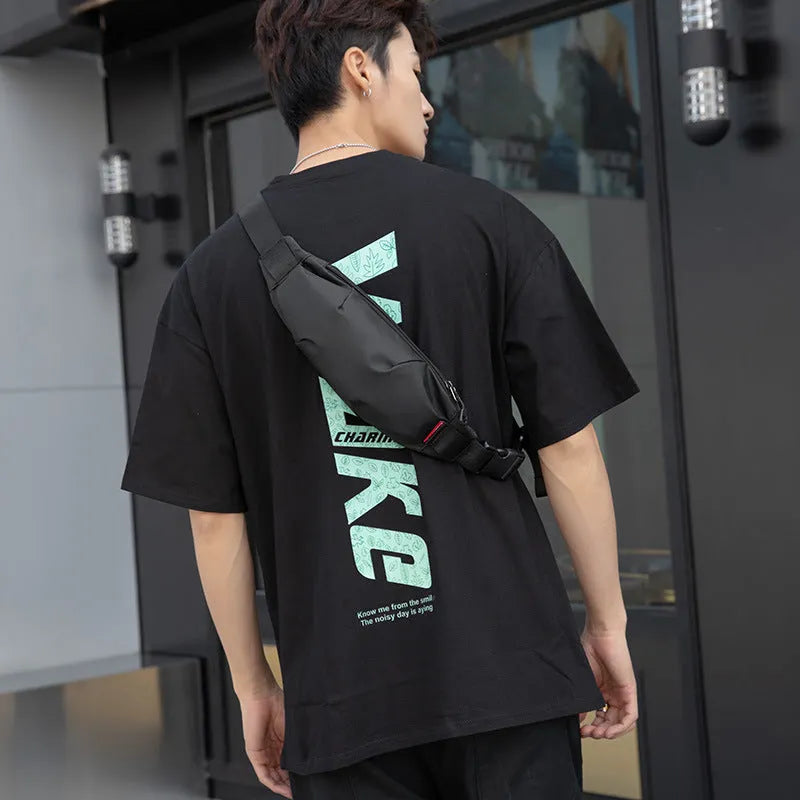 Black Oxford cloth crossbody waist pack with zippered opening showing interior organisation pockets