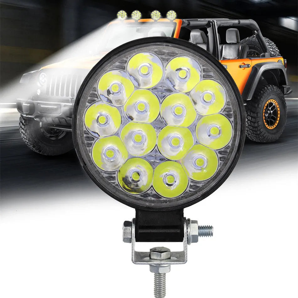 White LED mini round auxiliary work light with aluminium housing for vehicle mounting.