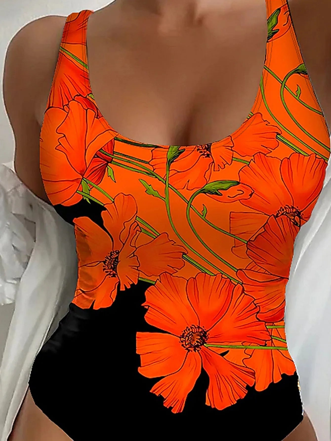 Orange flowers printed backless one-piece swimsuit laid flat, slim fit design.