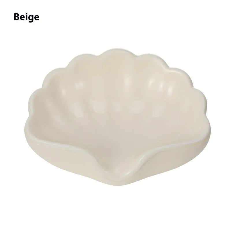 Plastic shell-shaped soap dish in pearl white or pink colour for bathroom organisation