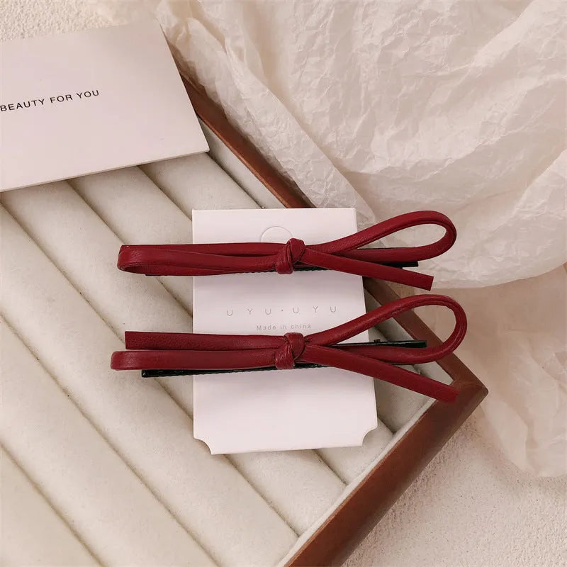 Wine red leather bow hair clip barrette showing advanced bow design and clip mechanism