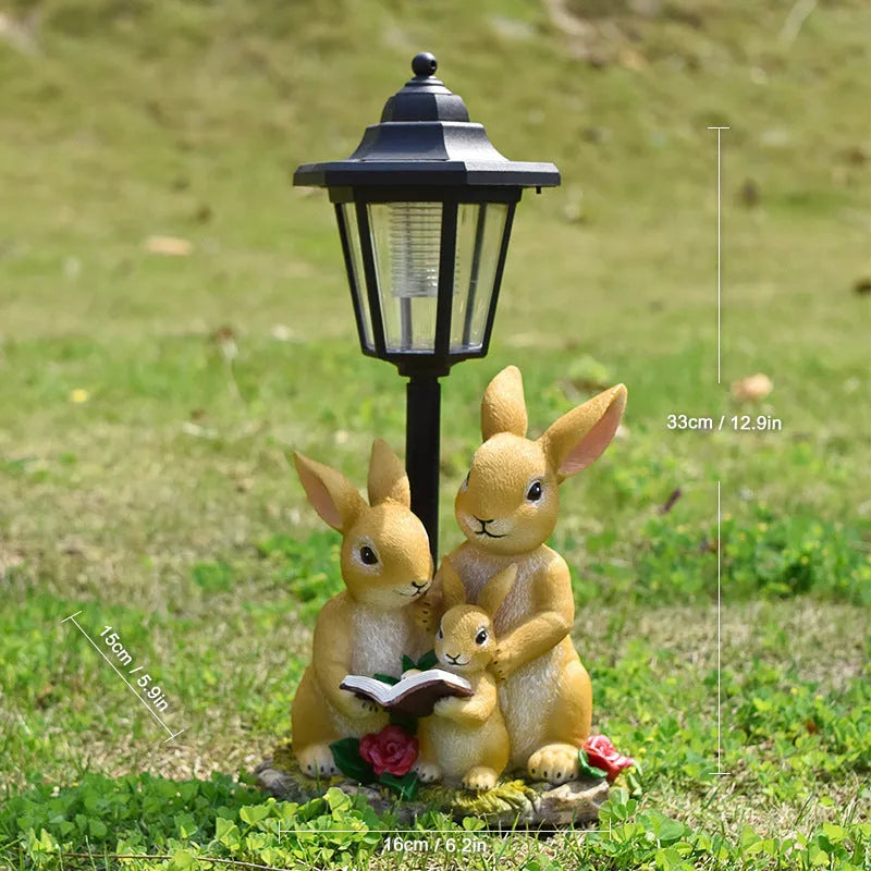 Solar hexagonal garden lamp with decorative resin figurine on plastic base for outdoor pathway lighting