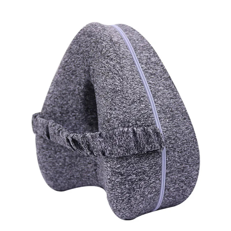 Heart-shaped dark blue memory foam leg pillow for adult knee or ankle support.