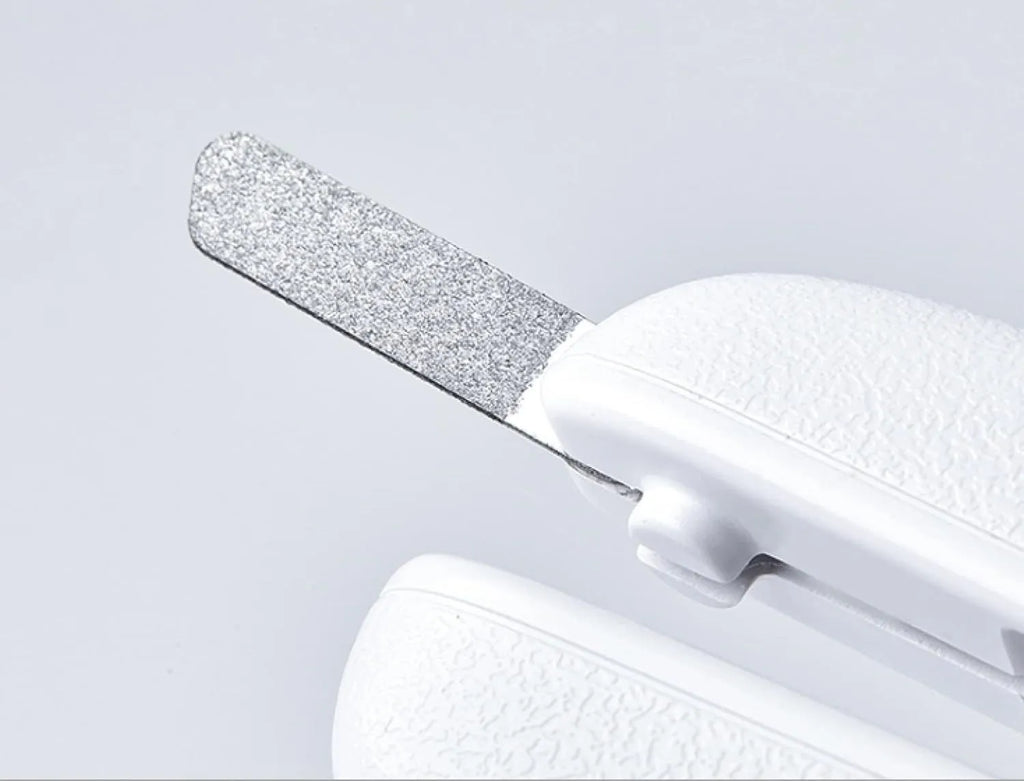 White pet nail clippers with LED light, transparent guard, and nail file for cats and dogs