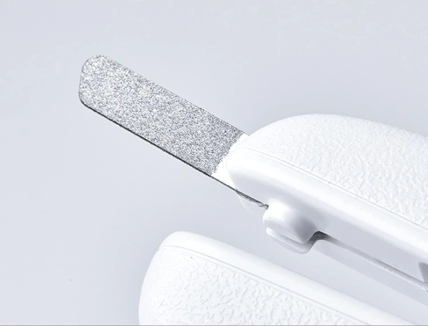 White pet nail clippers with LED light, transparent guard, and nail file for cats and dogs