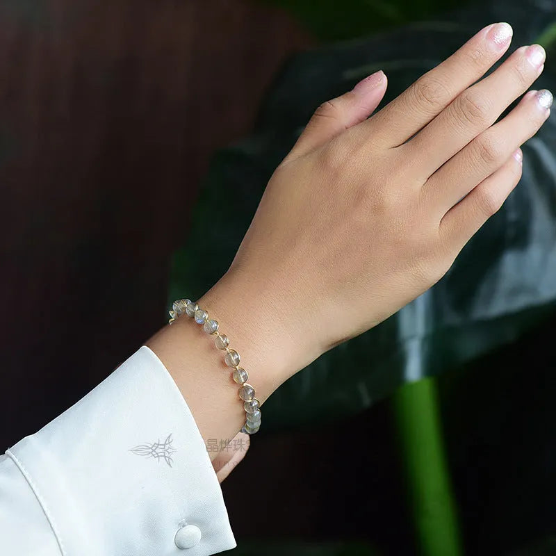 Women's blue moonstone bracelet with 6mm crystal and 14K gold-plated gilded metal band.