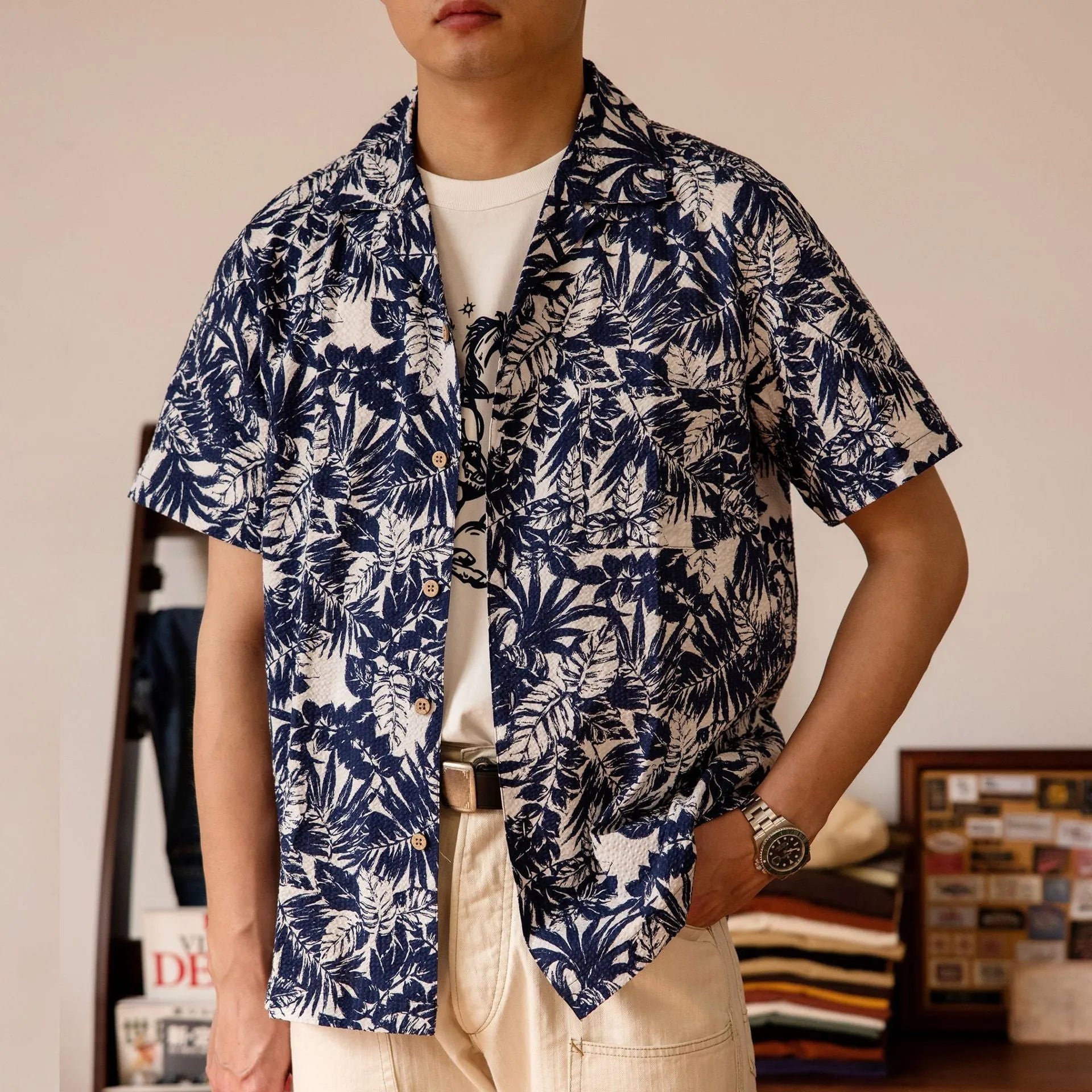Man wearing a vintage green seersucker shirt with floral print and a Cuban collar.