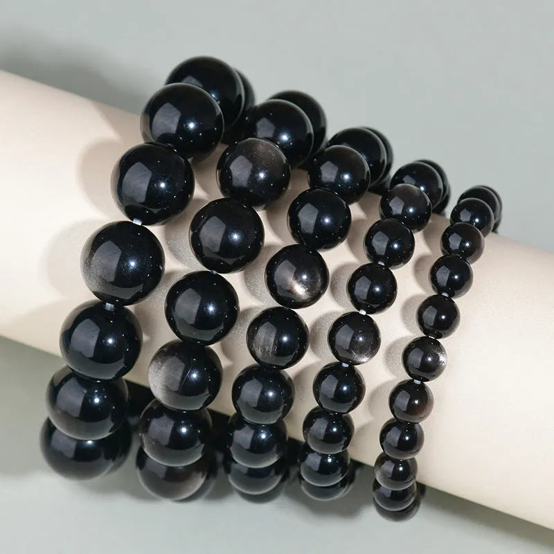 Hand-woven ethnic style unisex obsidian bracelet with round crystal beads.